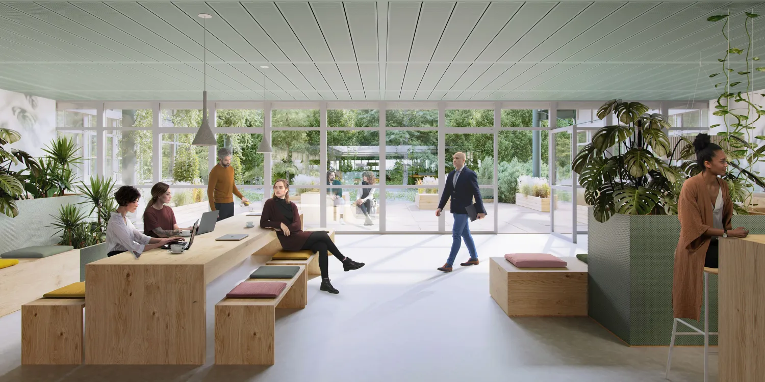 Offene Lounge im Frameworks mit Holzsitzmöbeln, begrüntem Außenbereich und fließendem Übergang zur Natur.