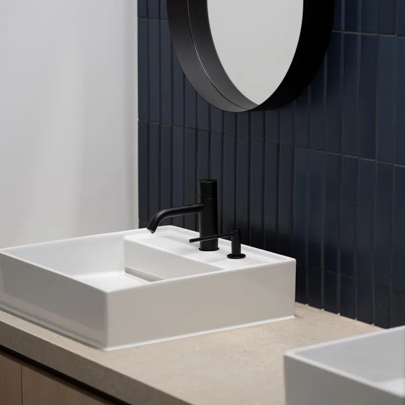  Waschtisch der Anwaltskanzlei Fish & Richardson – modernes Design mit schwarzer Armatur und blauen Fliesen.